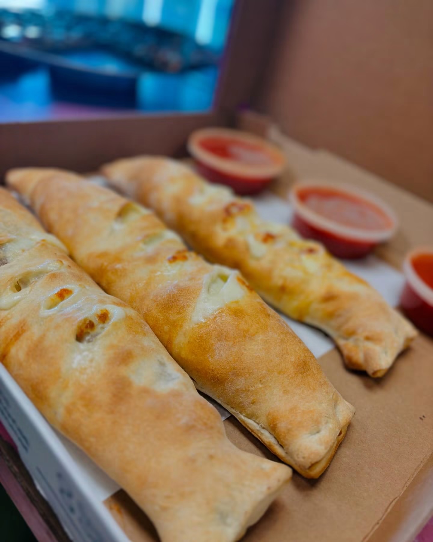 Freshly baked calzones with marinara sauce