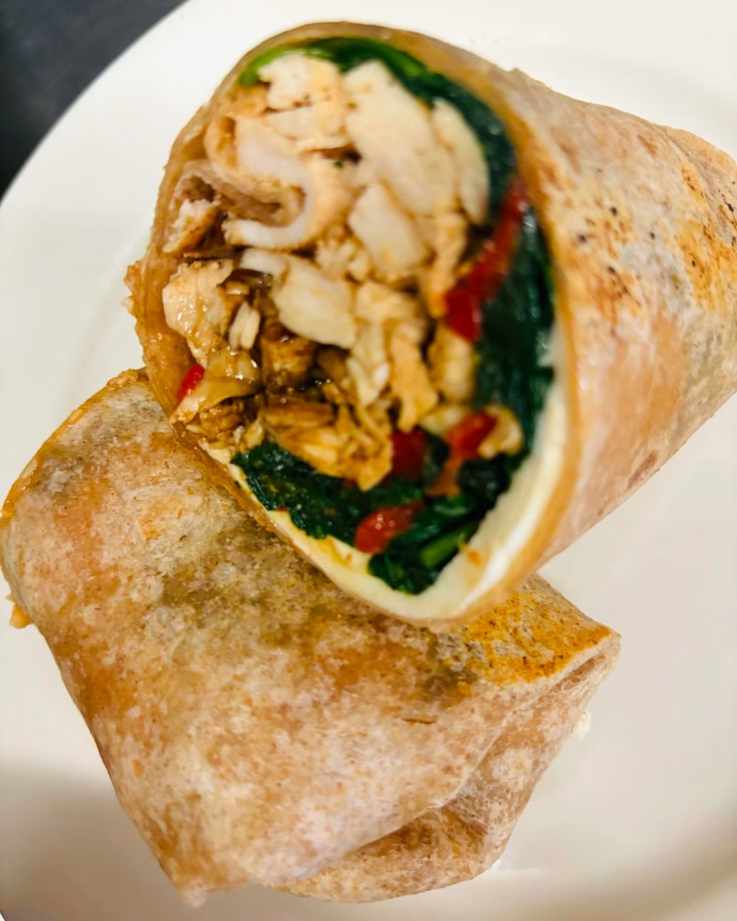 Chicken and vegetable wrap cut in half
