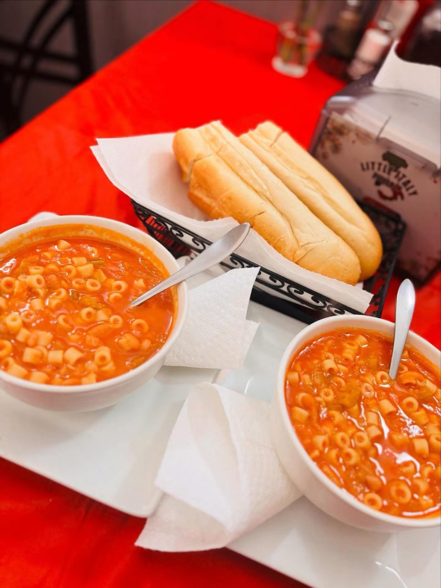 Two bowls of pasta and bean soup with bread